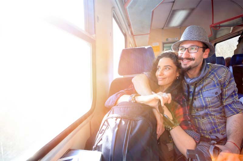 Carol and Freddy on a train look the scenery